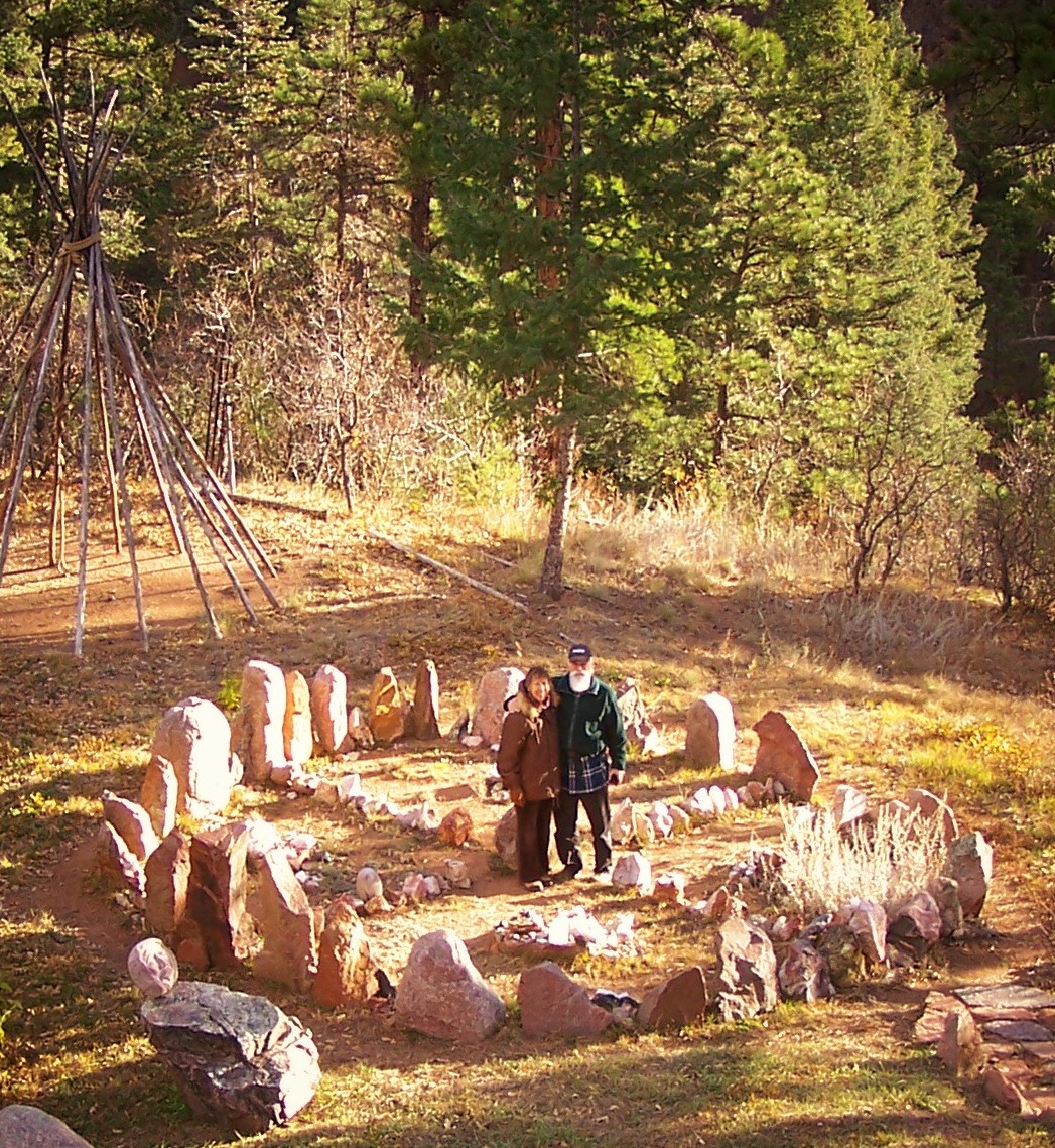 Couple standing in stone circle in forest